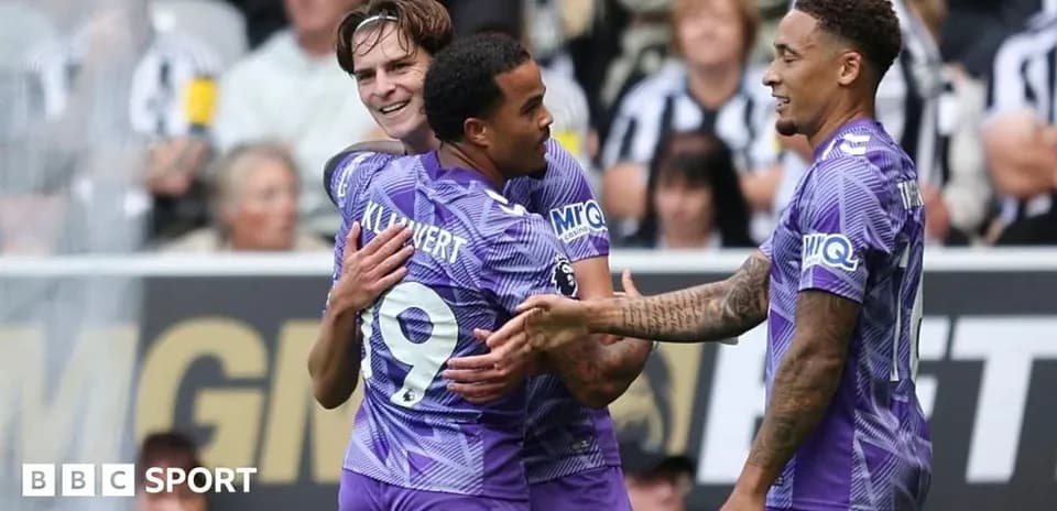 Three players celebrating a goal during match