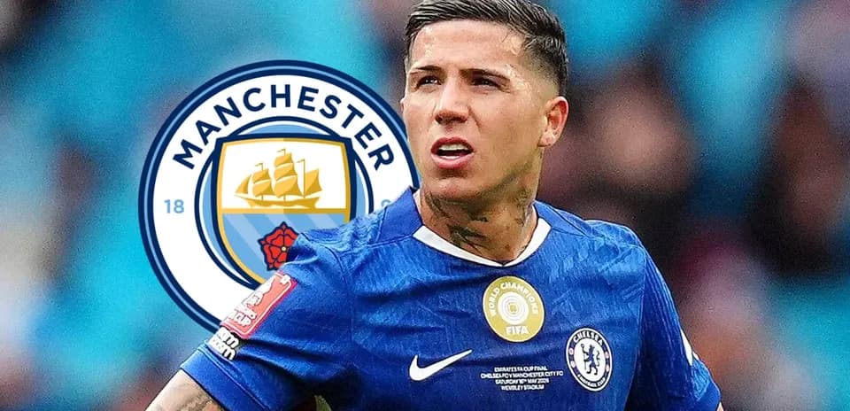 Player wearing Chelsea kit with Manchester City logo background