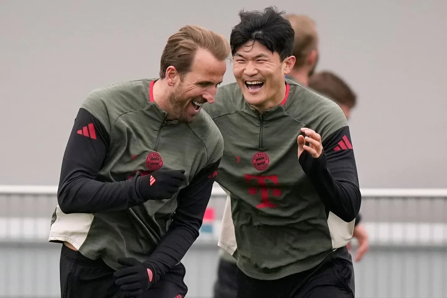 Two Bayern Munich players laughing during training session