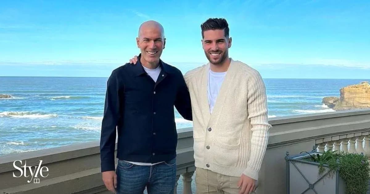 Two men posing together with ocean backdrop