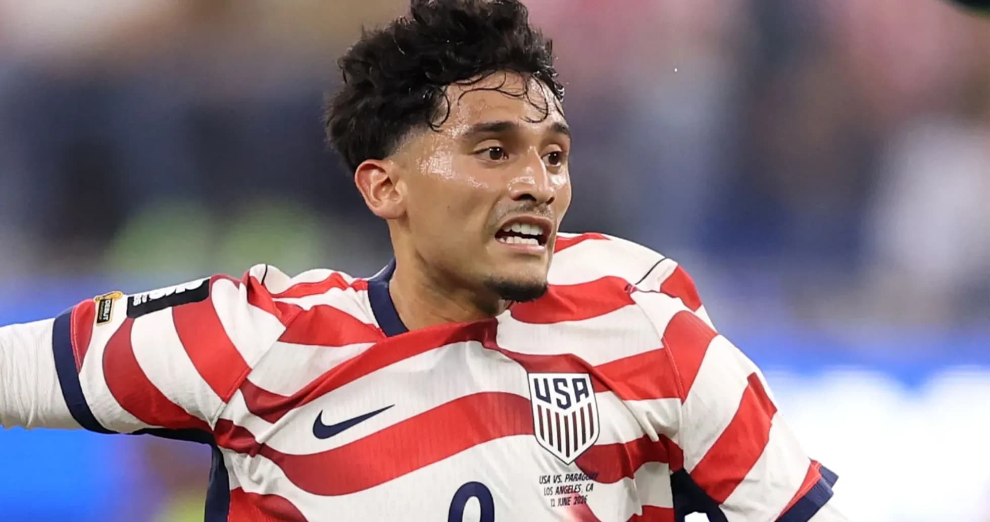 Player in striped USA jersey during match action