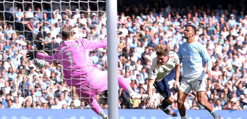 Goalkeeper saving a shot during football match