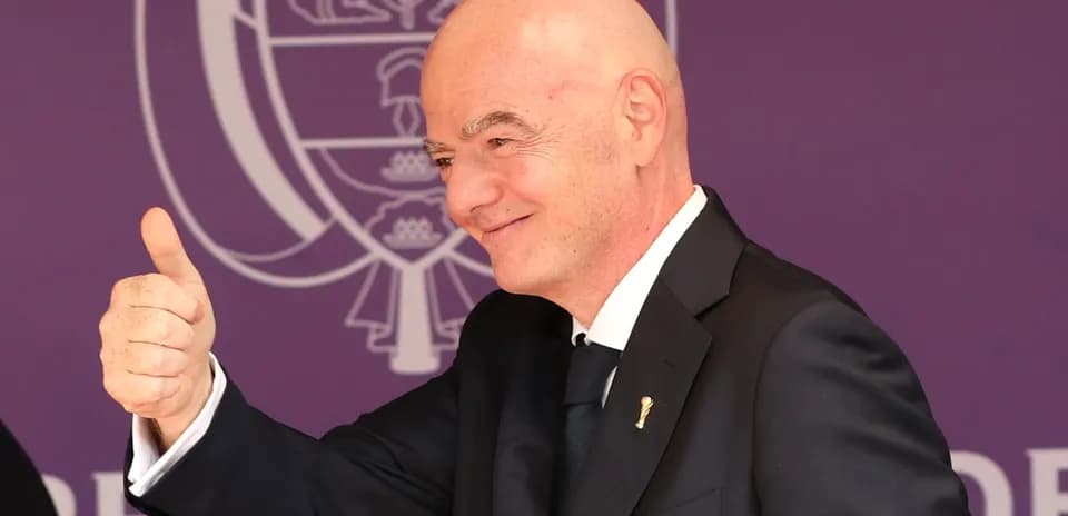 Man giving thumbs up at event backdrop