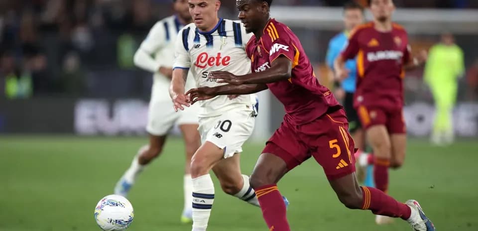 AS Roma player tackling Atalanta opponent