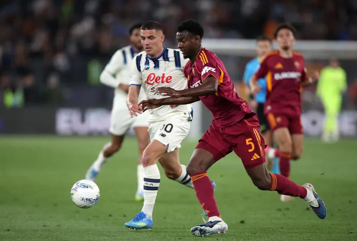 AS Roma player tackling Atalanta opponent