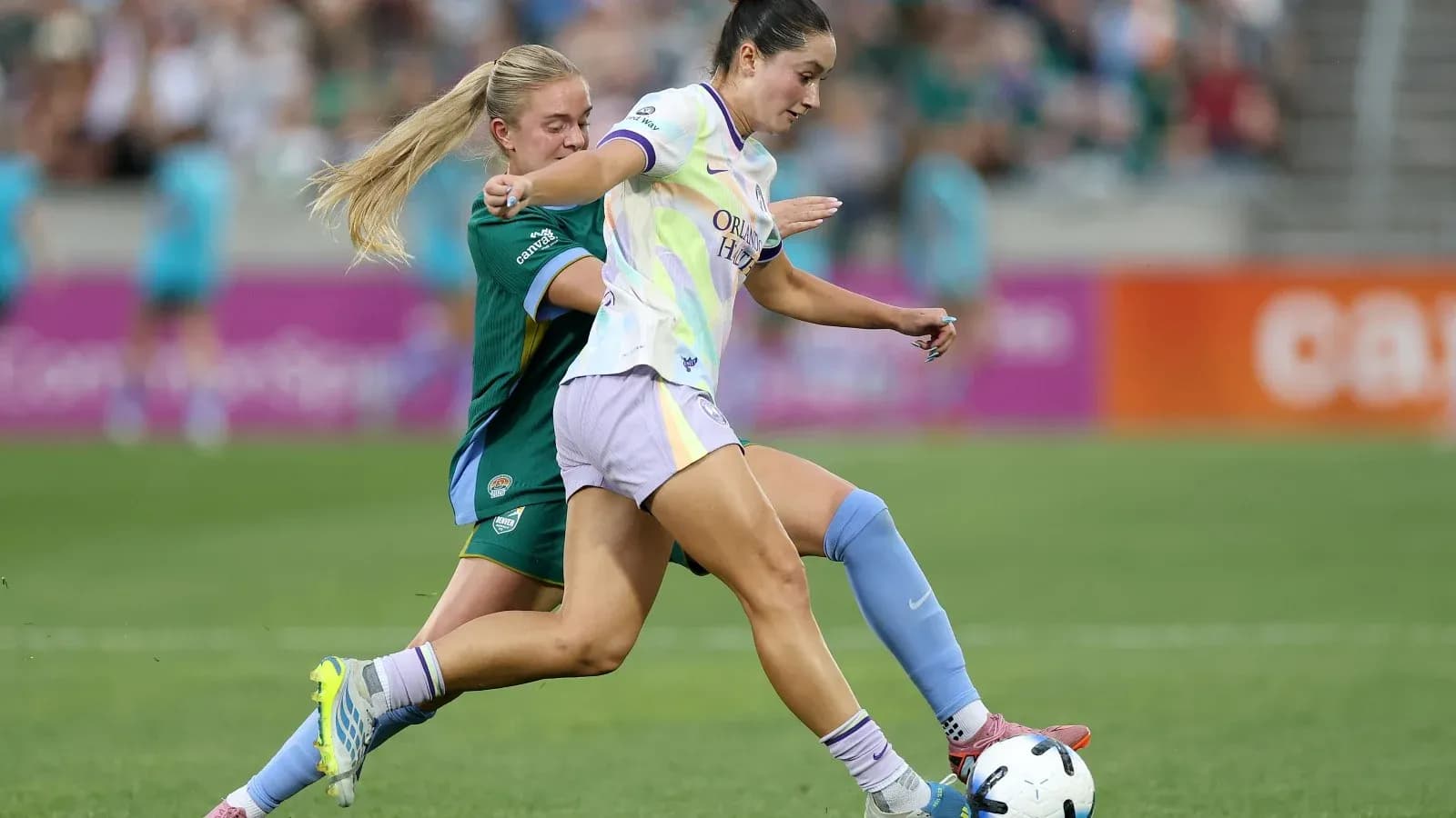 Orlando Pride player dribbling against Bay FC