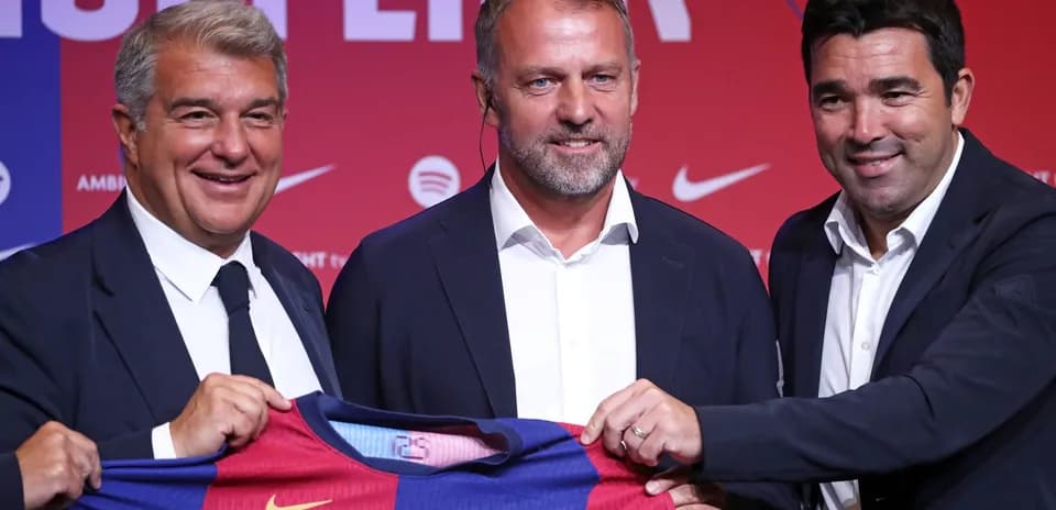 Three officials presenting FC Barcelona jersey at event