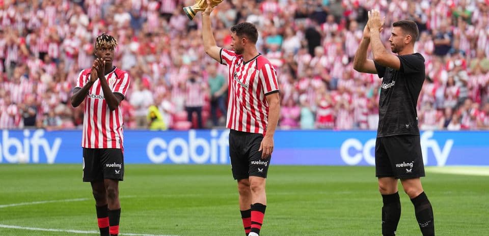 Players celebrating with a trophy in stadium