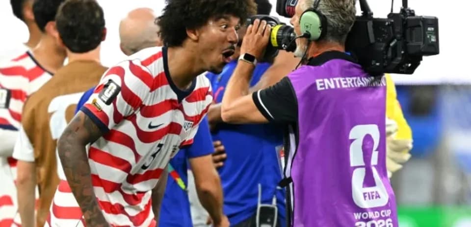 US player celebrating with cameraman after match