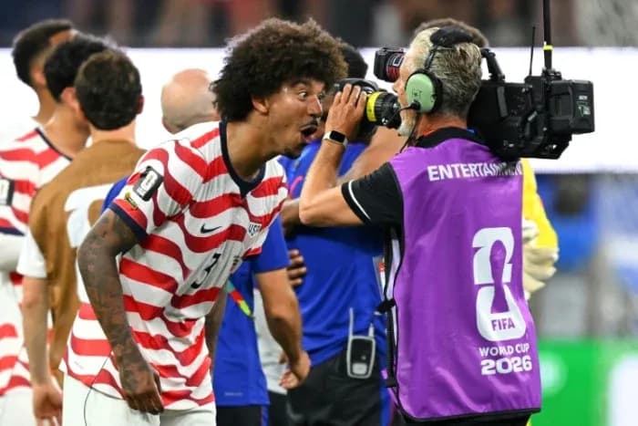 US player celebrating with cameraman after match