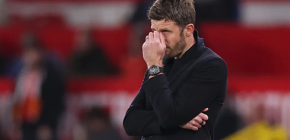 Manager with hand on face during match