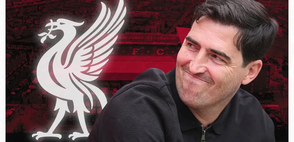 Man smiling with Liverpool FC logo in background