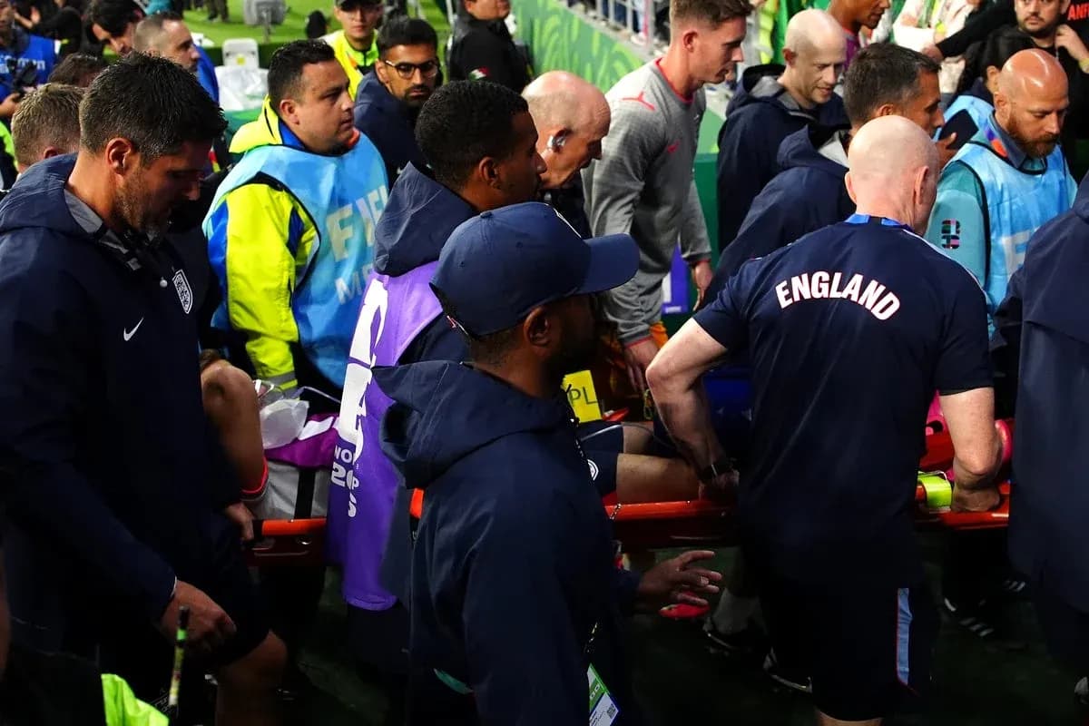 Medical staff assisting player on stretcher during match