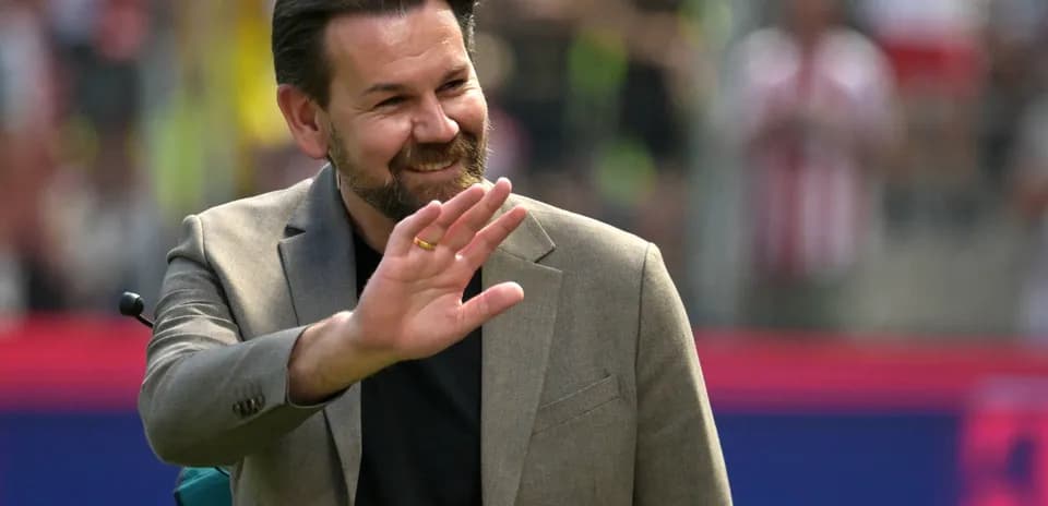 Man waving at the crowd during an event