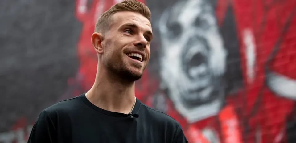 Player smiling in front of a mural background