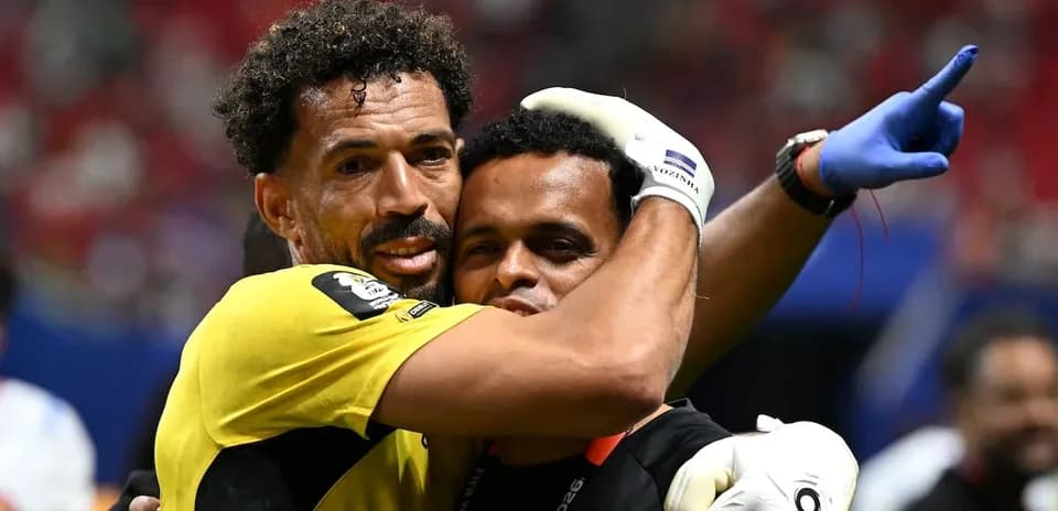 Goalkeeper and coach embracing after match