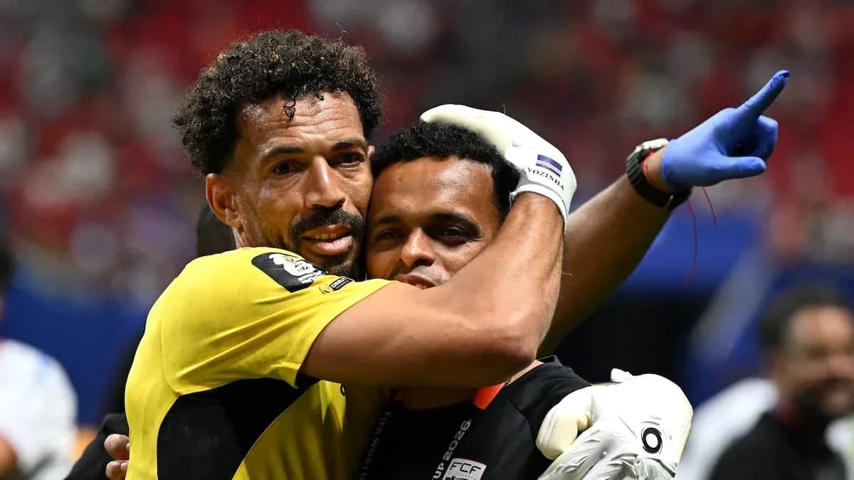 Goalkeeper and coach embracing after match
