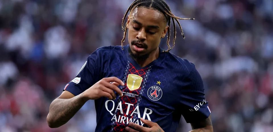 Player adjusting jersey with club badge during match