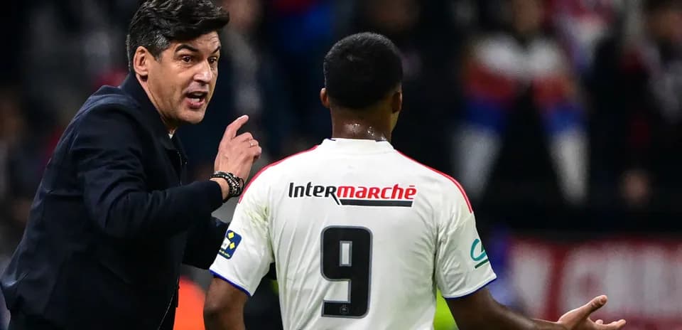 Coach giving instructions to player on the field