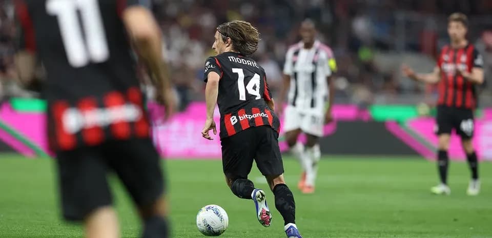 Player running with ball during AC Milan match