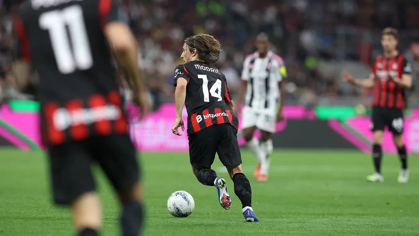 Player running with ball during AC Milan match