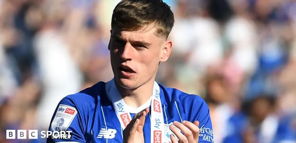 Player applauding with team medal around neck