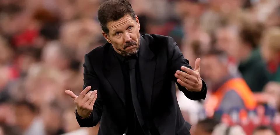 Manager gesturing during a match on the sidelines
