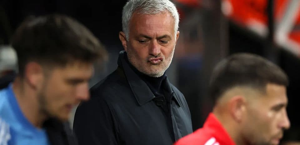 Manager observing players on the sideline during match