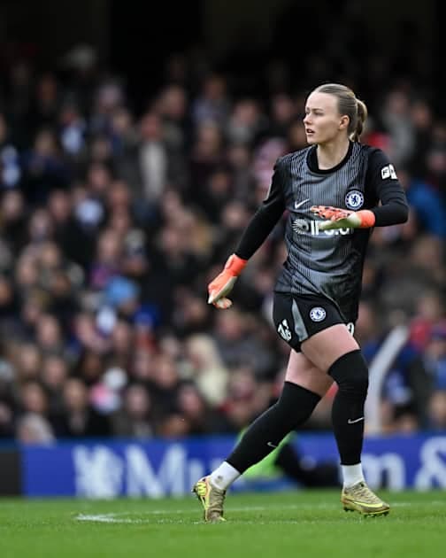 Goalkeeper in Chelsea kit during match action
