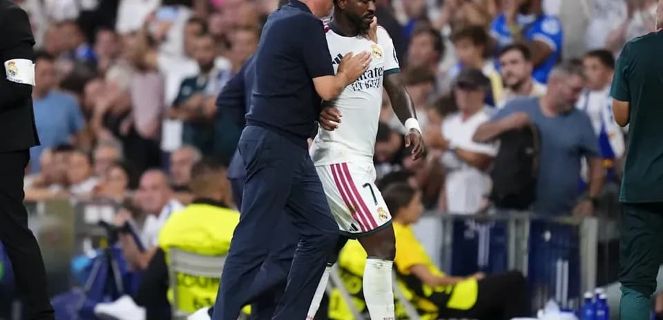 Coach discussing with player during match substitution