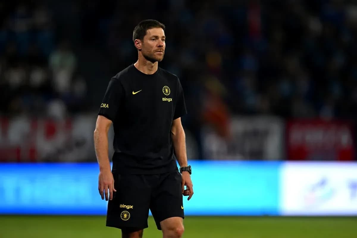 Coach walking on the pitch during match warm-up