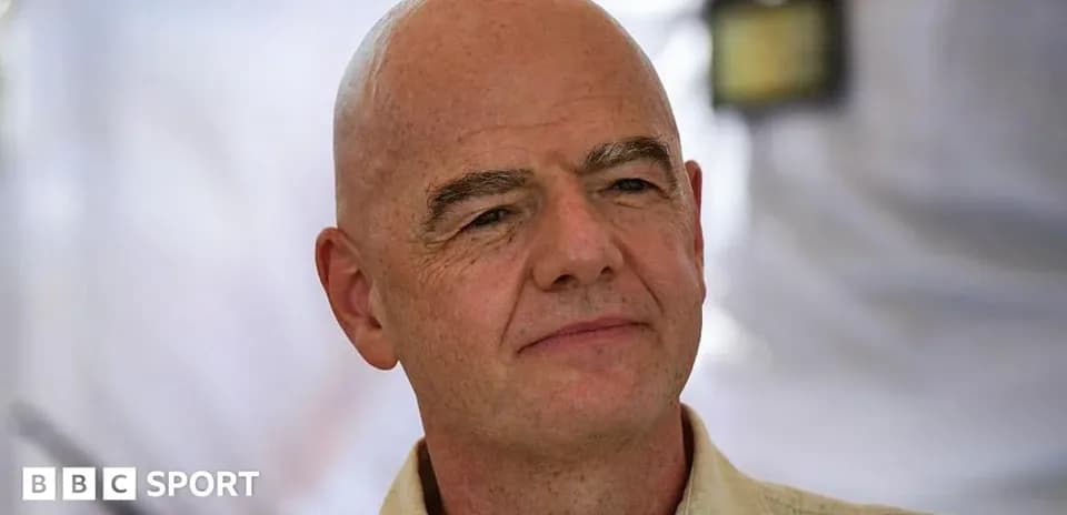 Man with bald head speaking at event