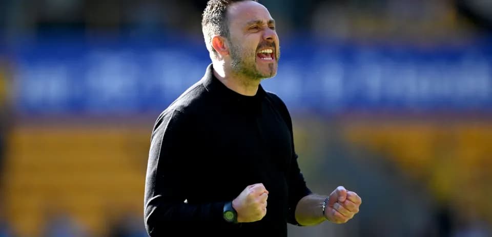 Coach celebrating during a match on the sidelines