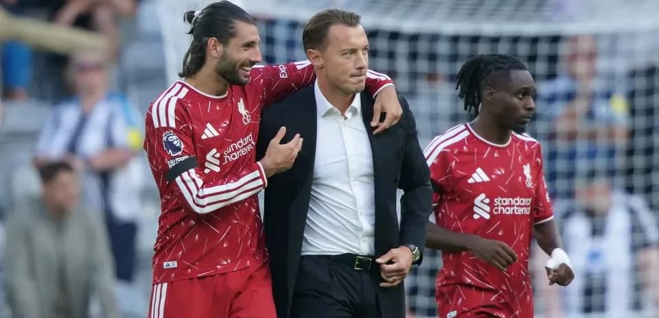 Liverpool players celebrating with their coach on field