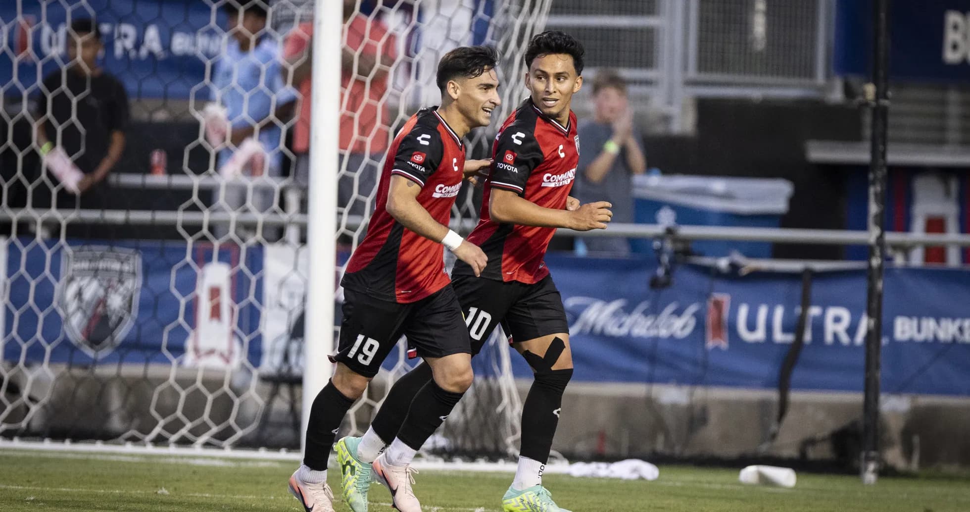 Two players celebrating a goal during match