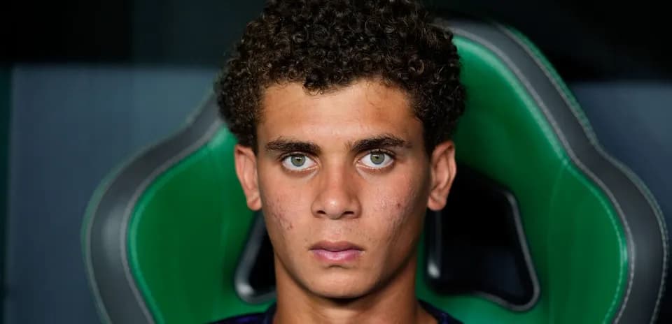 Young athlete sitting in green gaming chair