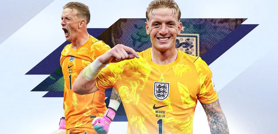 Goalkeeper in orange kit celebrating and posing