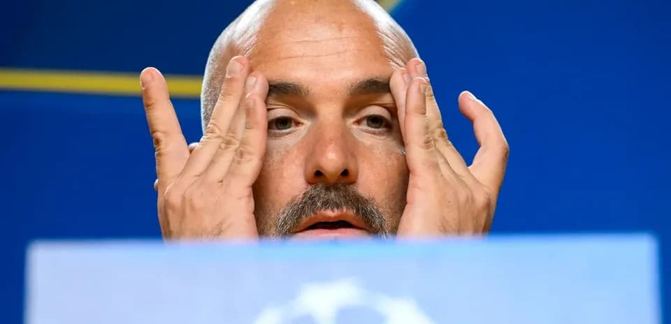 Manager at press conference with hands on face