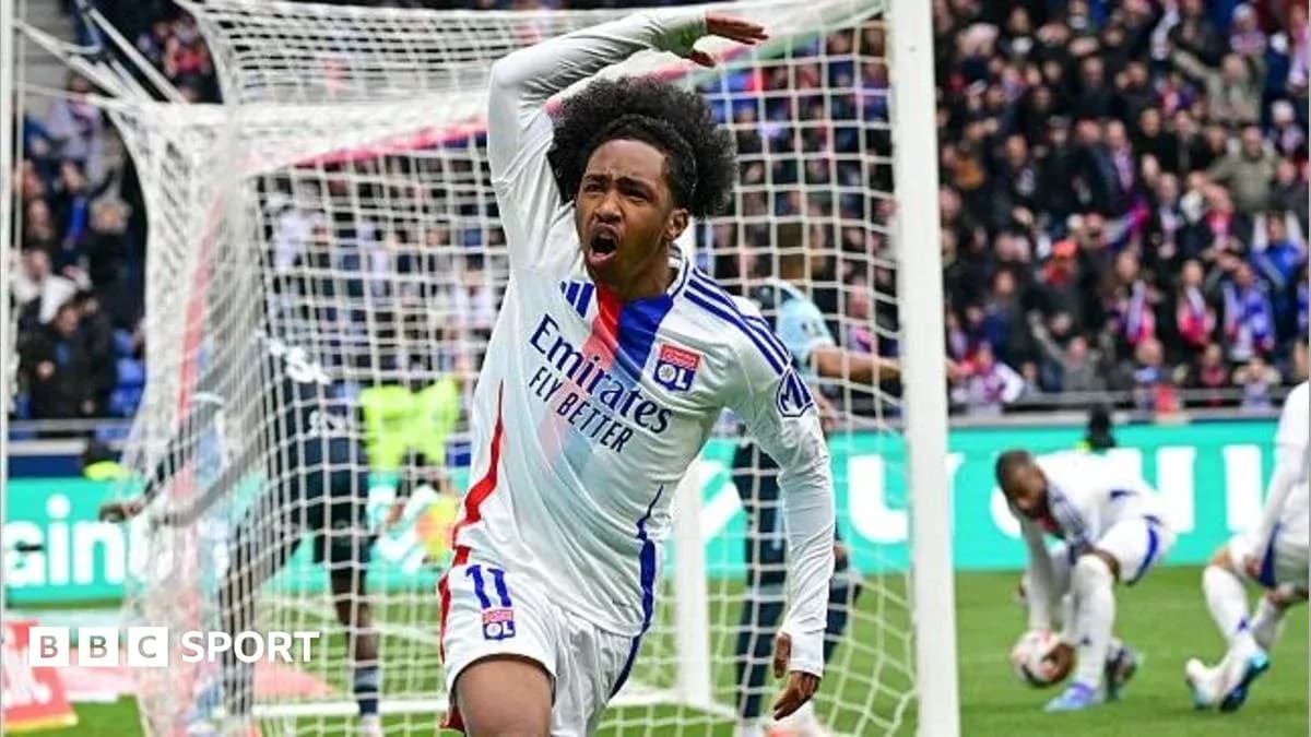Player celebrating a goal in front of the goalpost