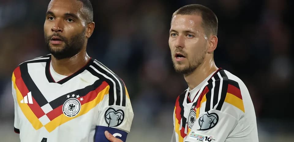 Two German players discussing during a match
