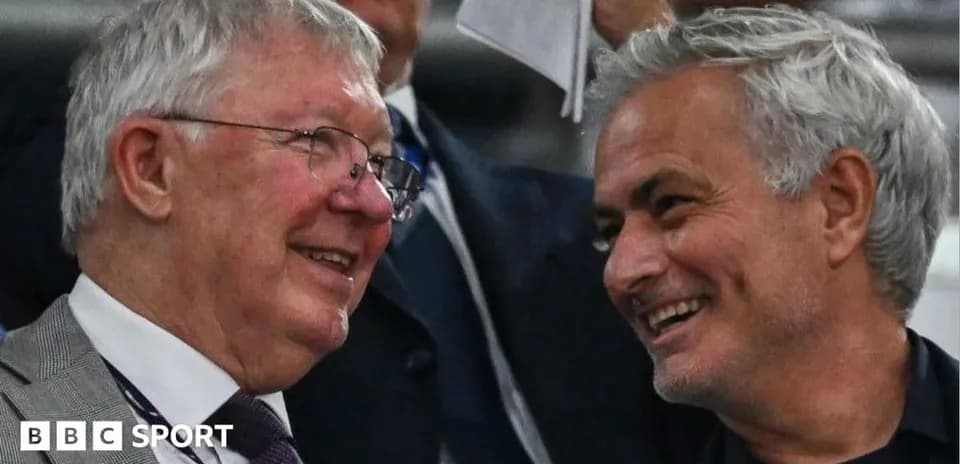Two men smiling and talking in the stands