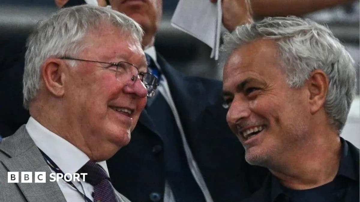 Two men smiling and talking in the stands