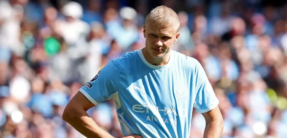 Player in light blue jersey on field with fans