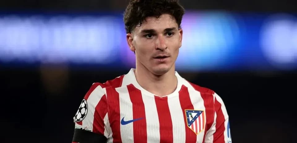 Atletico Madrid player in team jersey on pitch