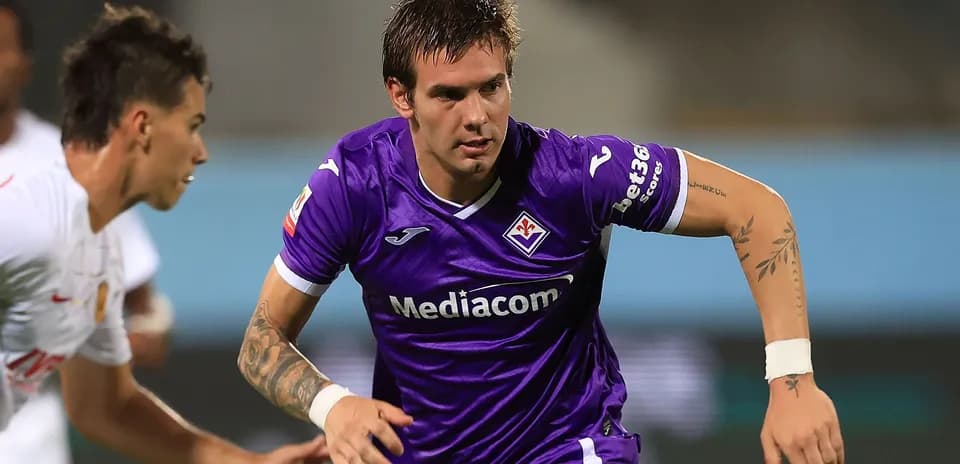 Player in purple jersey dribbling the ball during match