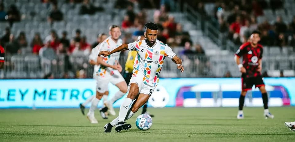 Player dribbling the ball during USL match