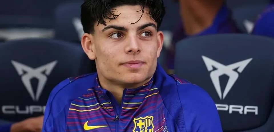 Barcelona player seated on bench during match