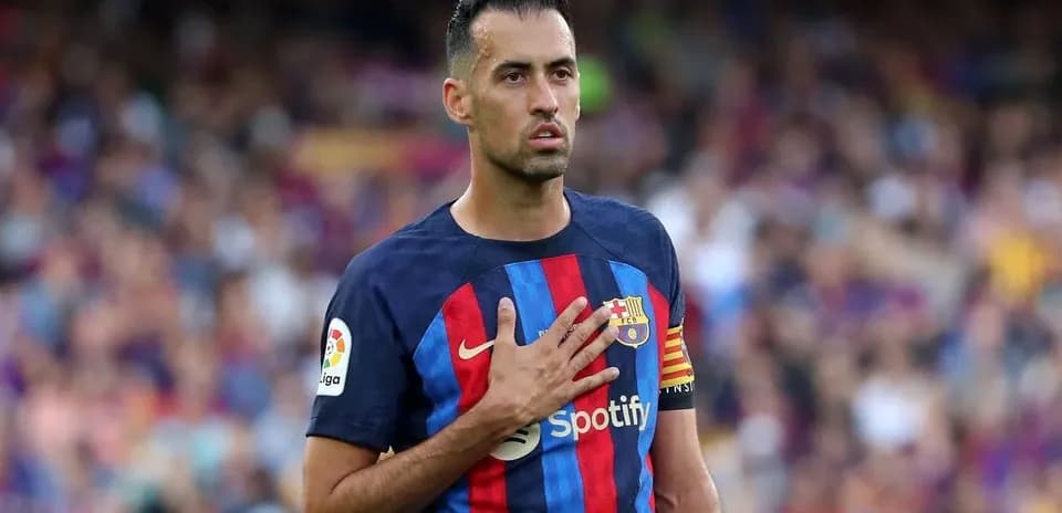 Sergio Busquets holding hand to chest during match