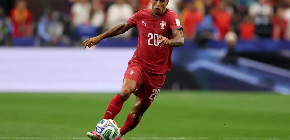 Player in red jersey sprinting with the ball