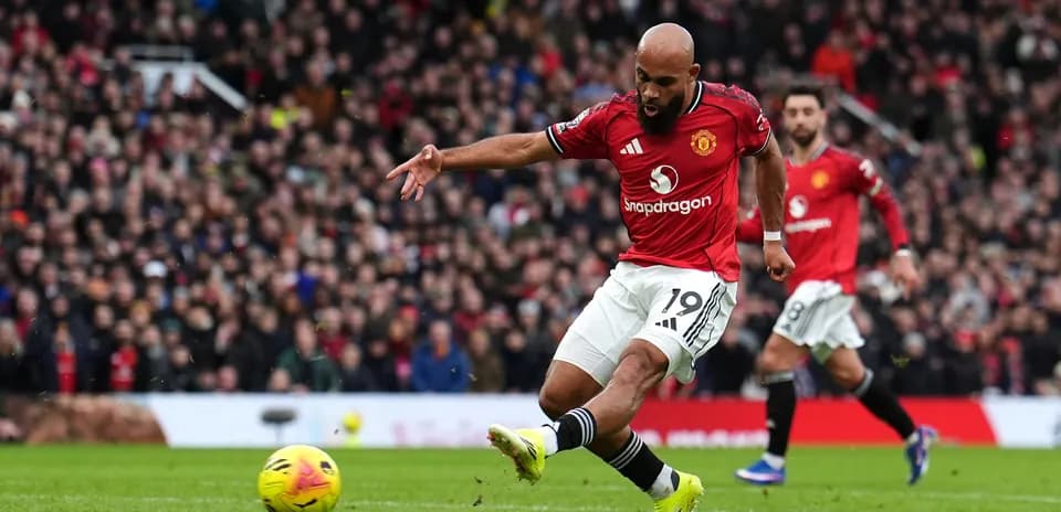Player kicking the ball during Manchester derby